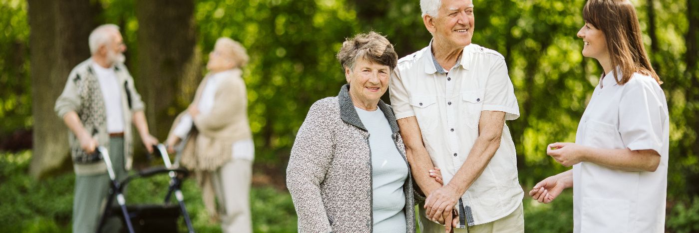 Elder people with the caregiver in the garden